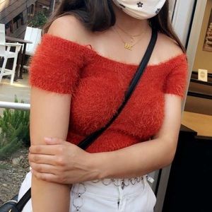 Fuzzy red over the shoulder top